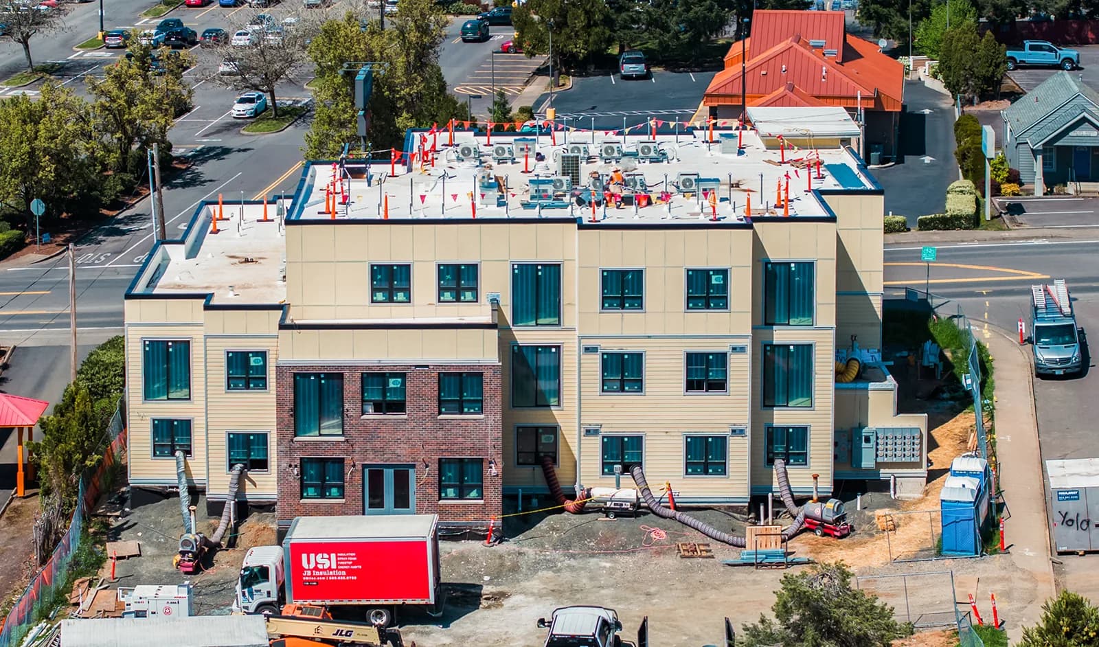 An overhead view of the same building's flat roof, penetrations and conduit stubs marked out across it