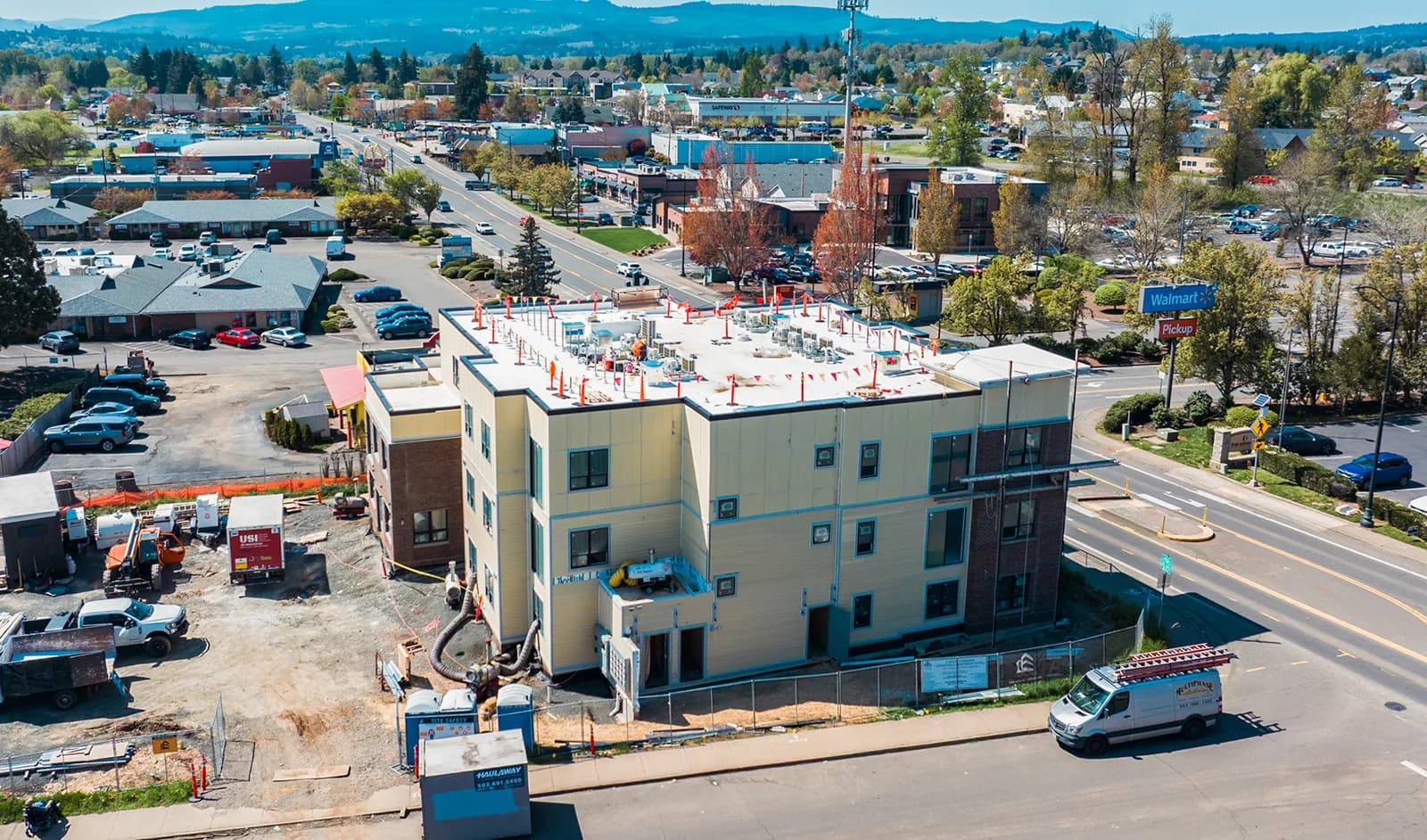 The mixed-use site from the air, the finished street elevation on one side and the working yard on the other