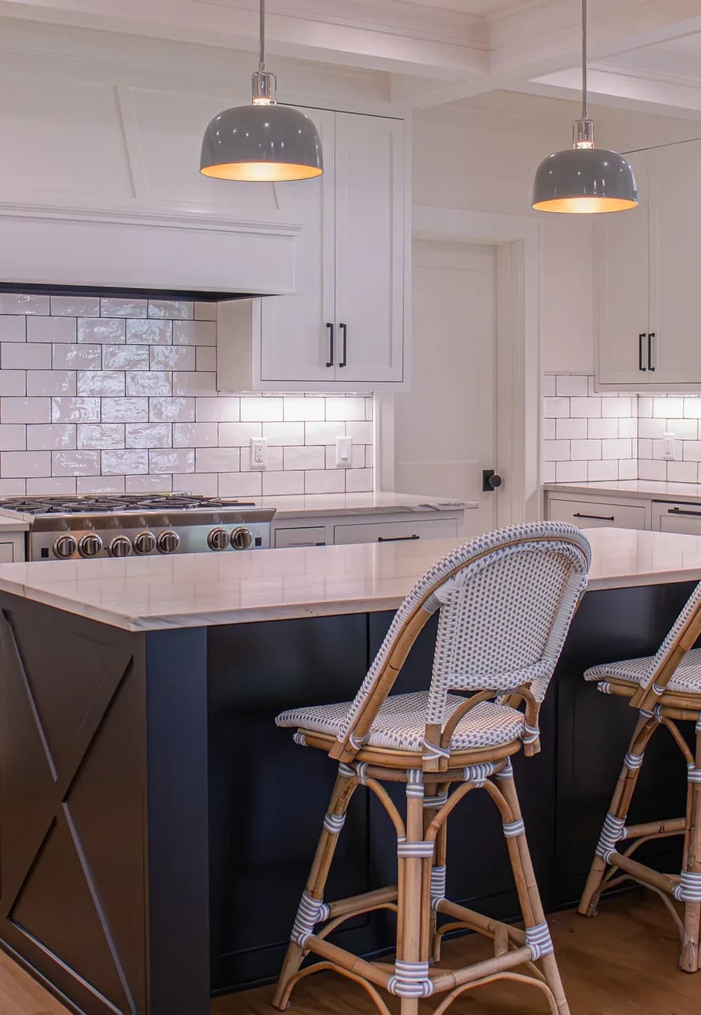 Rewired kitchen with pendants over the island, under-cabinet lighting, and new receptacles along the backsplash
